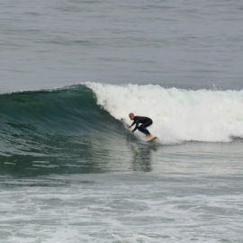 surfer on wave riding wave surfing right-hander ocean sea breaking wave surfer blacks beach california layback travel