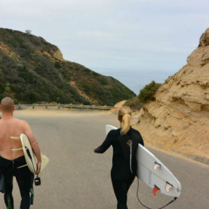surfer walking blacks beach california surfer girl surfboard layback travel