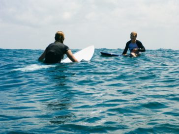 Girls surfing at Kuta Reef, Bali - Layback Travel