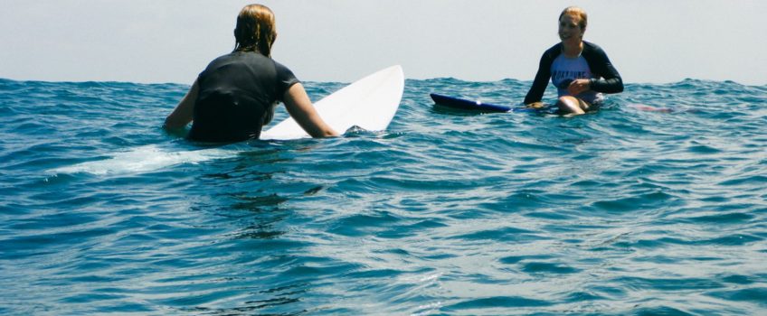 Girls surfing at Kuta Reef, Bali - Layback Travel