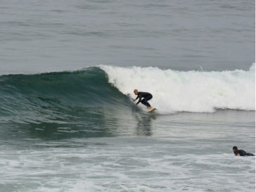 surfer on wave riding wave surfing right-hander ocean sea breaking wave surfer blacks beach california layback travel