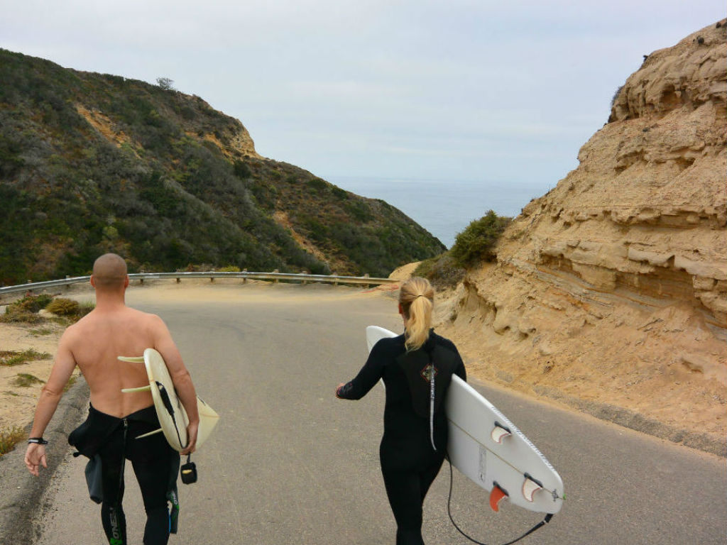 surfer walking blacks beach california surfer girl surfboard layback travel